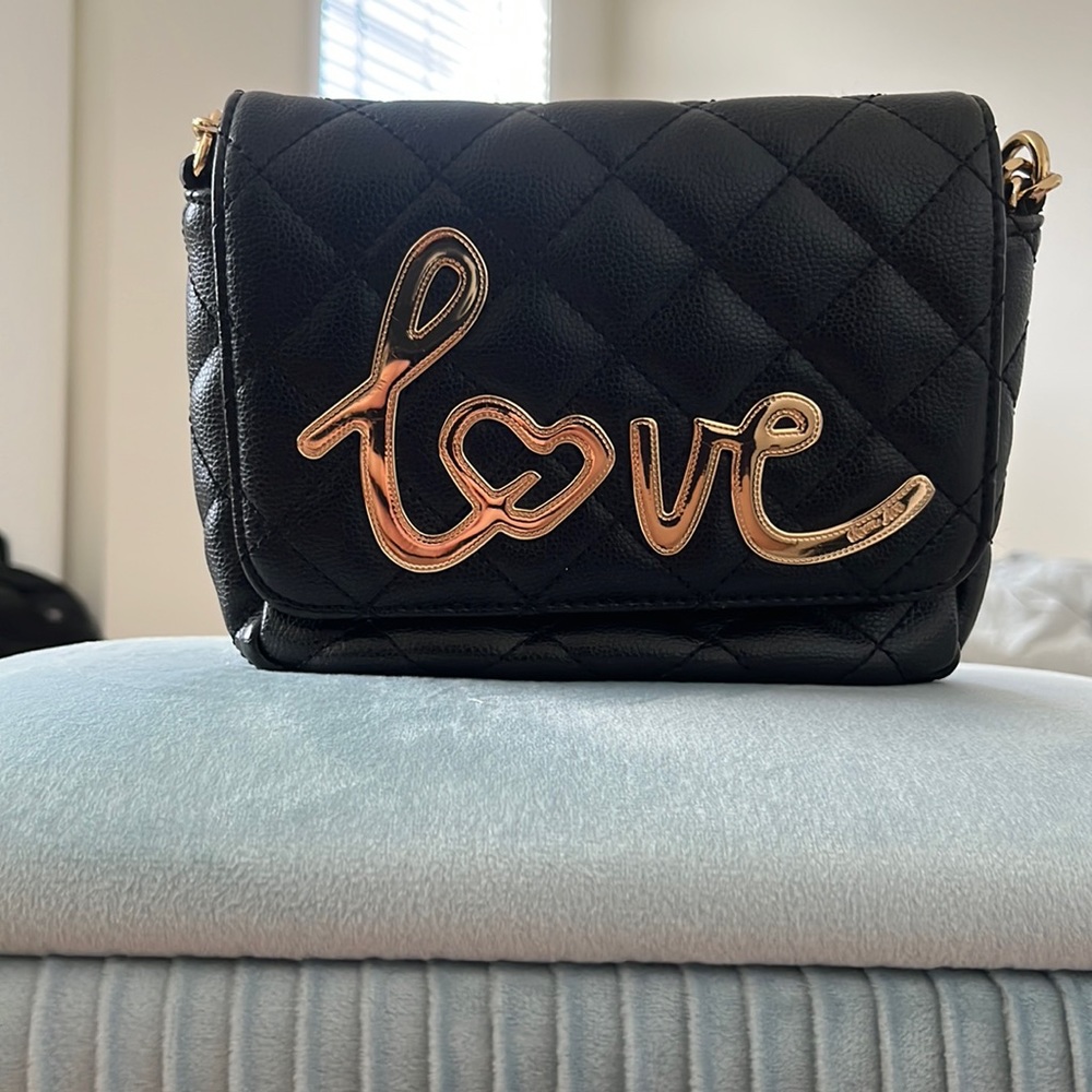 Handbag with gold and black chain. Love design